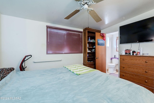 bedroom featuring ceiling fan and ensuite bath