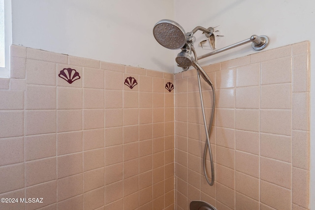 bathroom with tiled shower