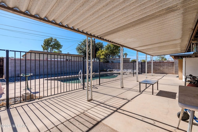 view of patio with a fenced in pool