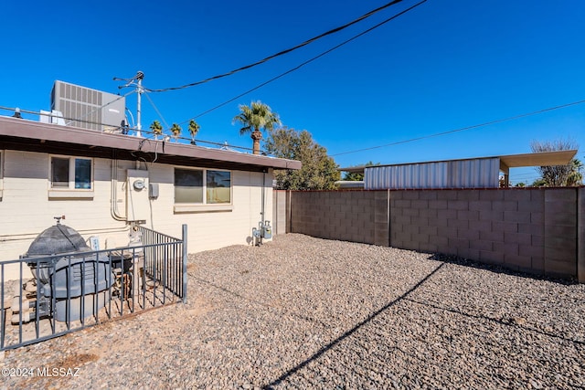 rear view of property with central AC