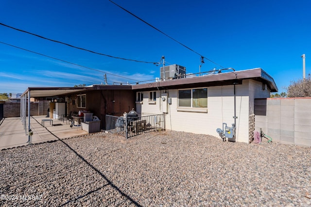 back of house with cooling unit and a patio area