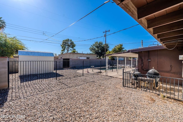 view of yard with a patio area and an outdoor structure