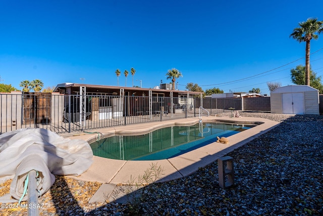 view of swimming pool with a patio area and a storage unit