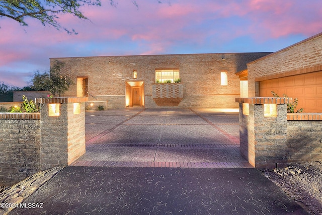 gate at dusk with a garage