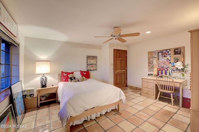 bedroom with ceiling fan and light tile patterned flooring