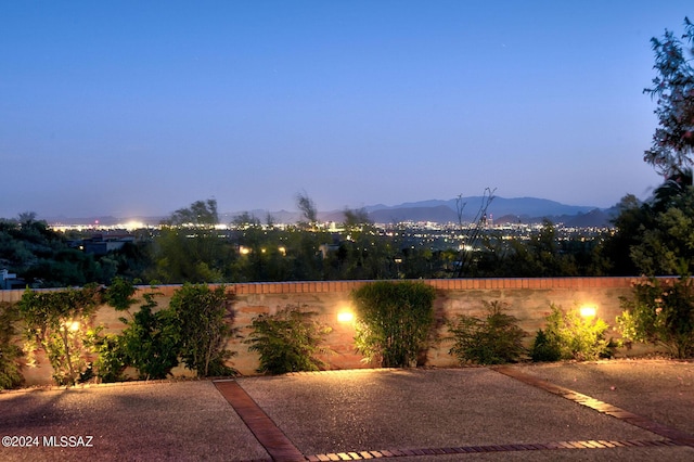 patio terrace at dusk featuring a mountain view