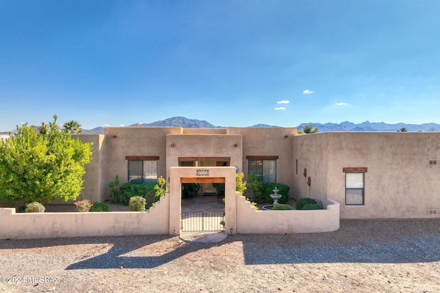 pueblo-style home with a mountain view