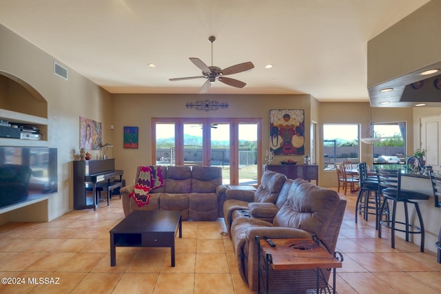 tiled living room with ceiling fan