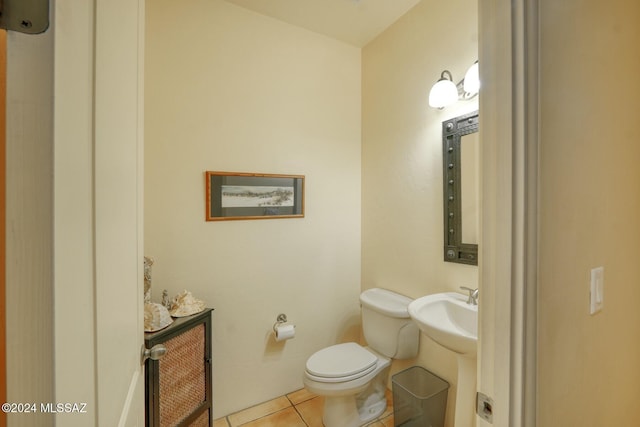 bathroom with tile patterned flooring, toilet, and sink