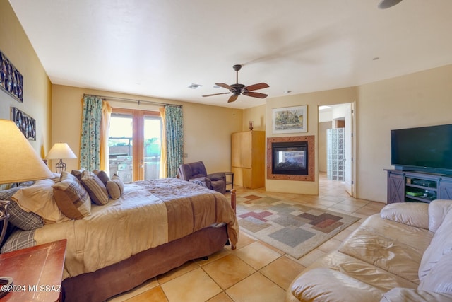 bedroom with ceiling fan and light tile patterned flooring