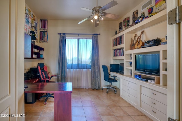 tiled office with ceiling fan and built in desk