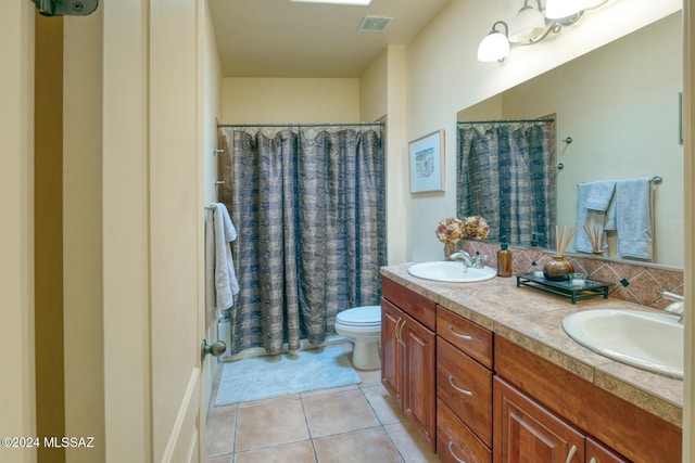 full bathroom with toilet, shower / tub combo, vanity, and tile patterned floors