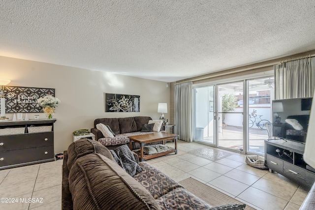 tiled living room featuring a textured ceiling