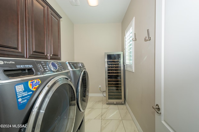 laundry area with cabinets, beverage cooler, and independent washer and dryer