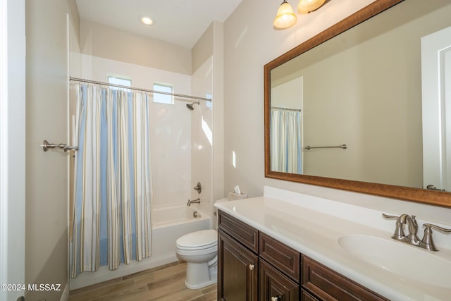 full bathroom featuring shower / bath combo, vanity, hardwood / wood-style flooring, and toilet