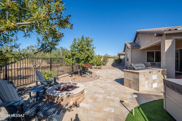 view of patio / terrace featuring area for grilling and an outdoor fire pit