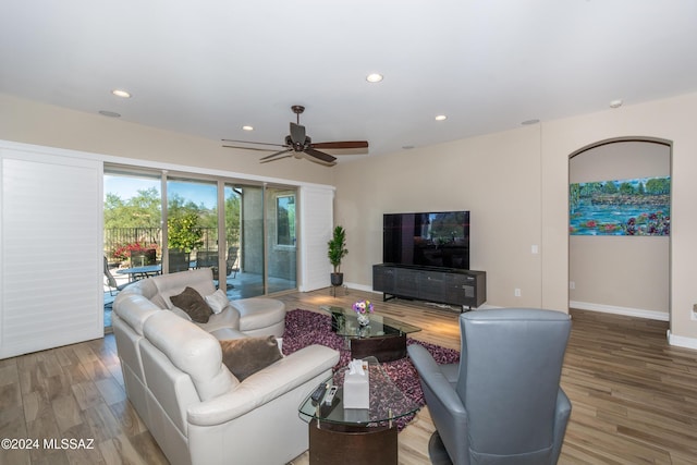 living room with hardwood / wood-style floors and ceiling fan