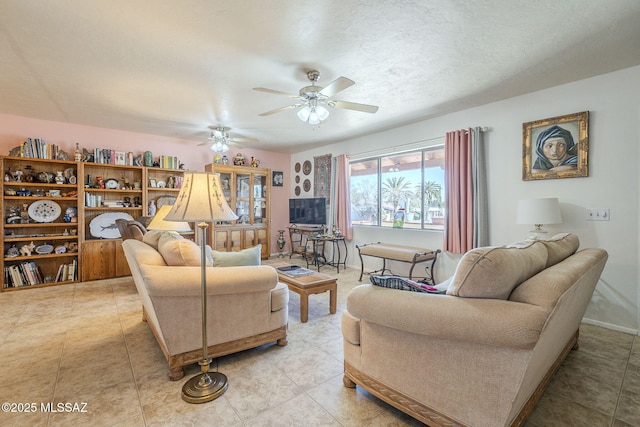 tiled living room with ceiling fan and a textured ceiling