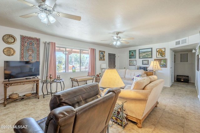 tiled living room with ceiling fan