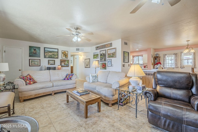 living room featuring ceiling fan and light tile patterned flooring