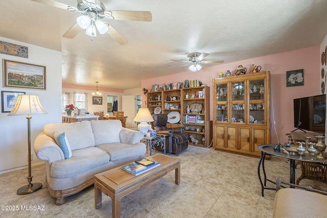 tiled living room with ceiling fan