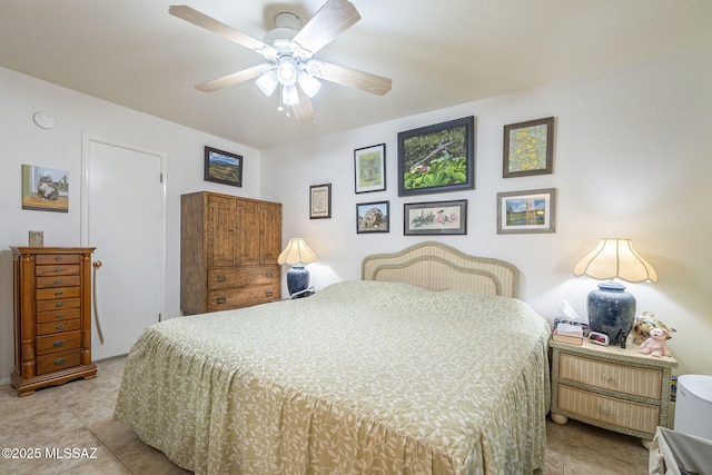 bedroom with ceiling fan and light tile patterned flooring