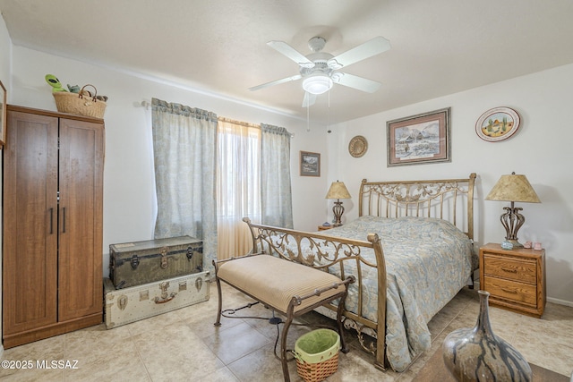 tiled bedroom featuring ceiling fan