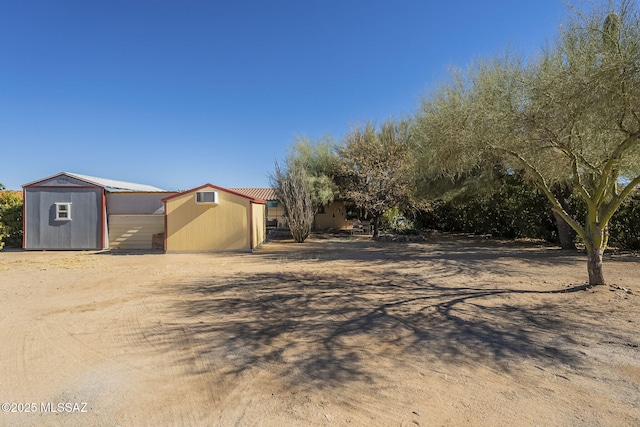 view of front of house featuring a storage unit