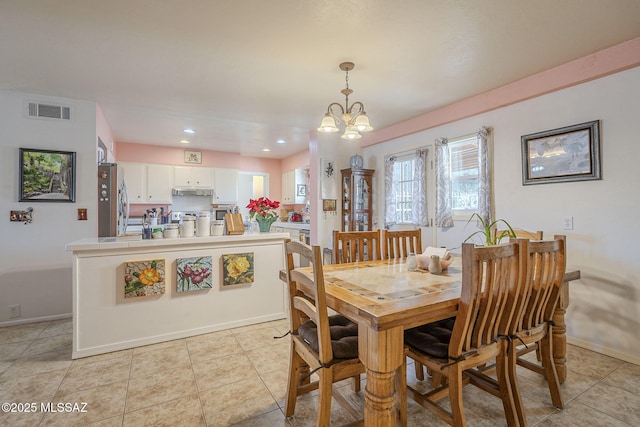 dining area featuring an inviting chandelier