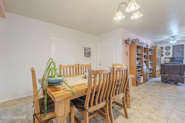 tiled dining room with ceiling fan with notable chandelier