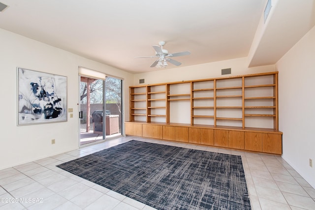 unfurnished room with light tile patterned floors, visible vents, and a ceiling fan