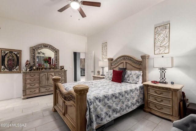 tiled bedroom featuring ceiling fan