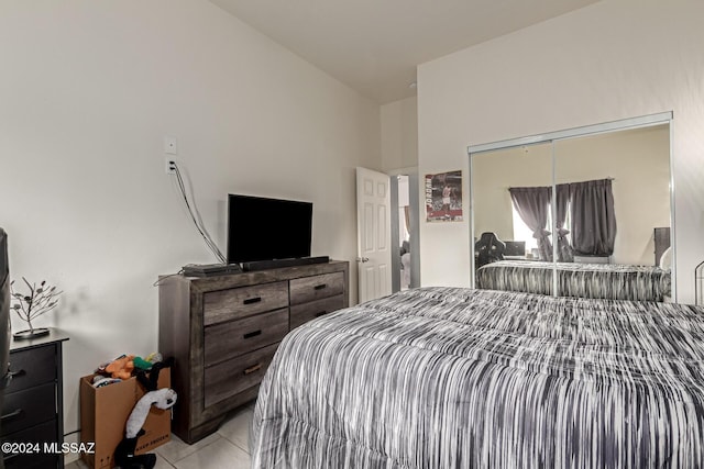 tiled bedroom with a closet and vaulted ceiling