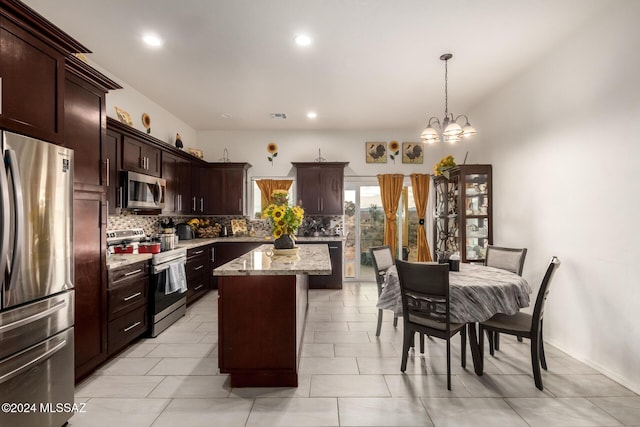 kitchen with hanging light fixtures, a notable chandelier, a kitchen island, dark brown cabinets, and stainless steel appliances