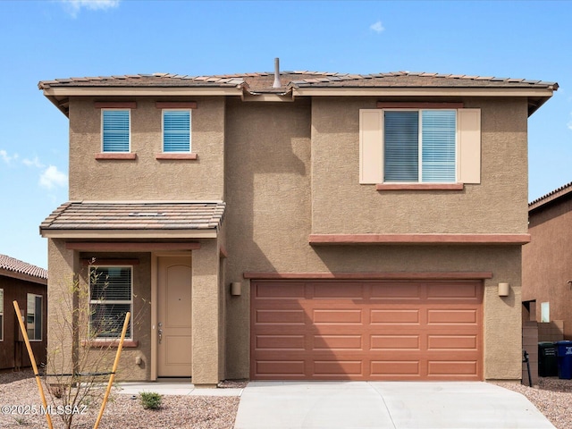 view of front of property with stucco siding, concrete driveway, and a garage