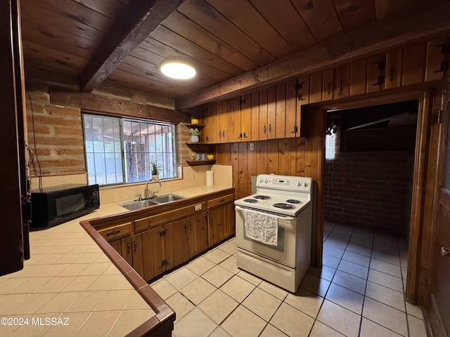 kitchen with tile countertops, wood walls, wooden ceiling, white range with electric cooktop, and sink