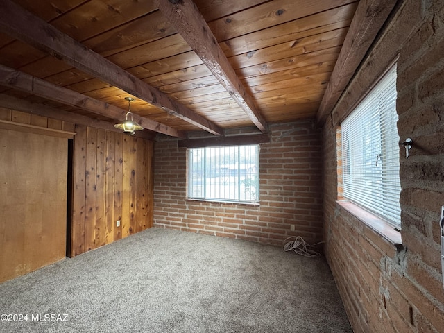 interior space featuring beam ceiling, wood ceiling, wood walls, and brick wall