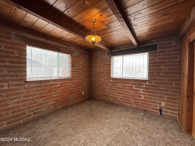 unfurnished room featuring beam ceiling, carpet flooring, and brick wall