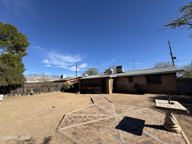 rear view of property with cooling unit