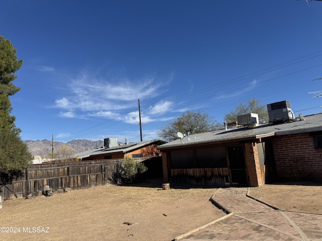 view of yard with a mountain view and central air condition unit