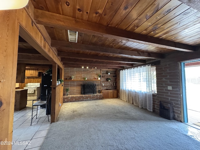 unfurnished living room featuring beamed ceiling, light colored carpet, a brick fireplace, and wooden ceiling