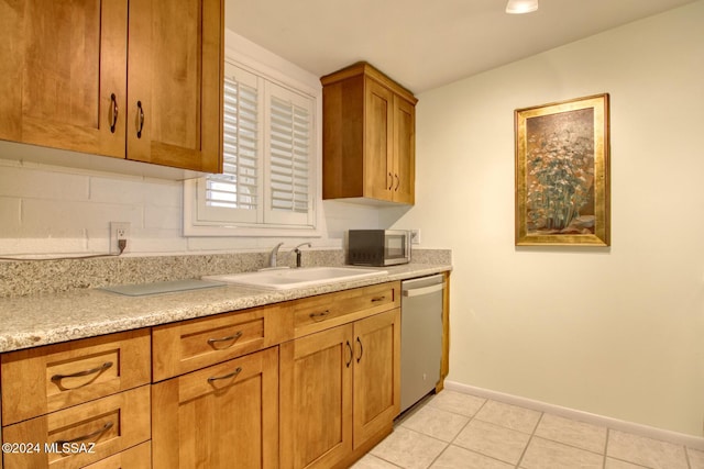 kitchen featuring tasteful backsplash, sink, light tile patterned floors, and stainless steel appliances