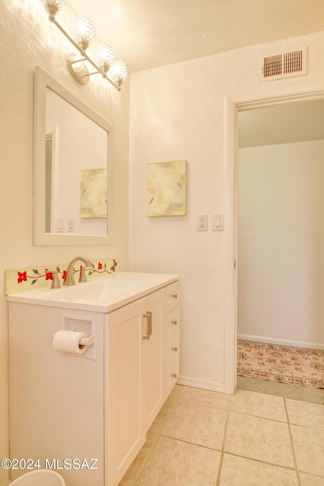 bathroom with tile patterned floors and vanity