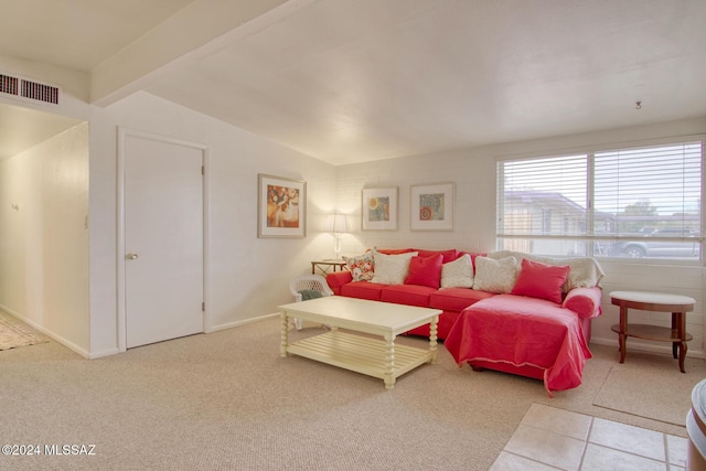 living room featuring vaulted ceiling with beams and light carpet