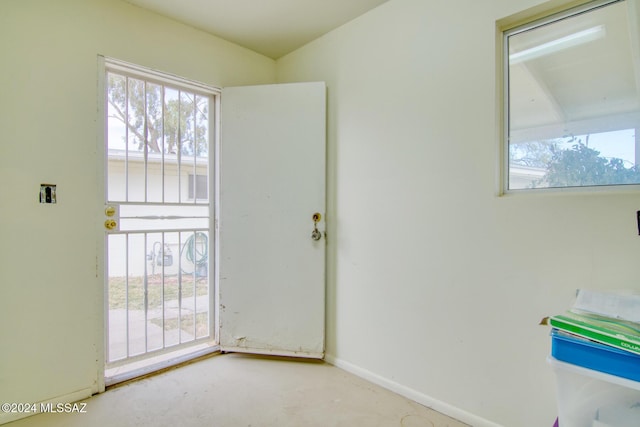 doorway featuring concrete flooring and a healthy amount of sunlight