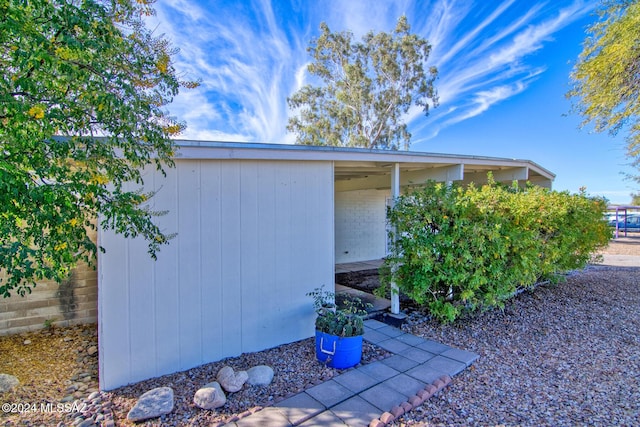 view of side of property featuring a storage unit