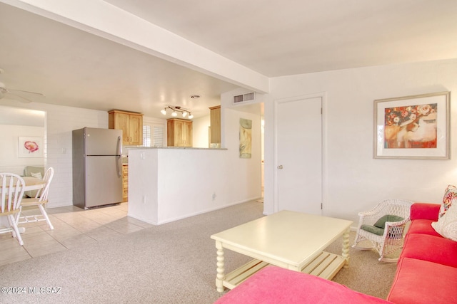 living room featuring light carpet, beamed ceiling, and ceiling fan