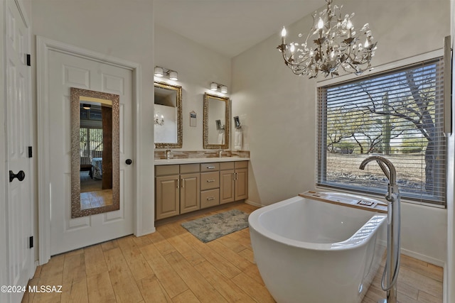 bathroom featuring a tub to relax in, vanity, and hardwood / wood-style flooring