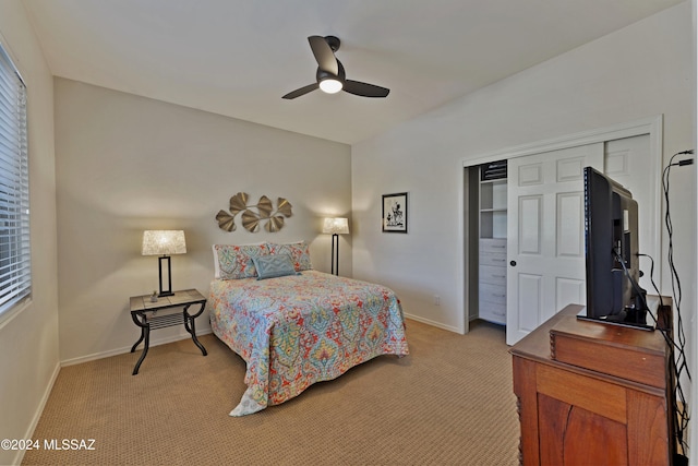 bedroom featuring ceiling fan, a closet, and light carpet