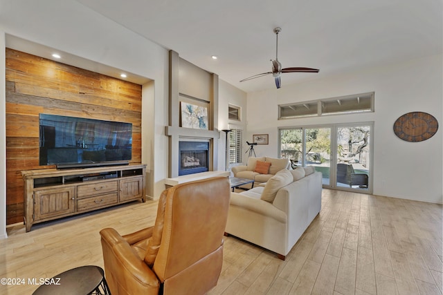 living room with ceiling fan and light wood-type flooring